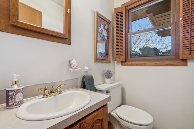 bathroom with toilet and vanity