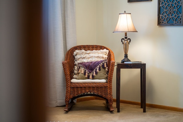 sitting room featuring carpet flooring and baseboards