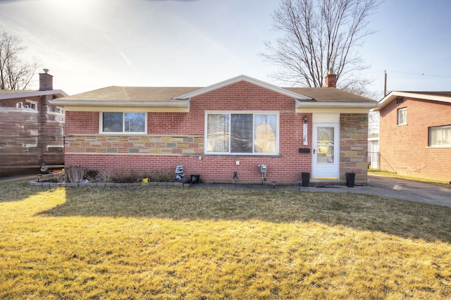 bungalow featuring stone siding, a front yard, a shingled roof, brick siding, and a chimney