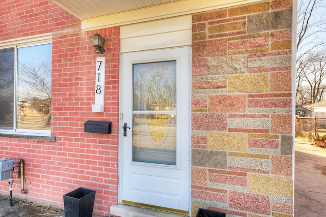 entrance to property with brick siding