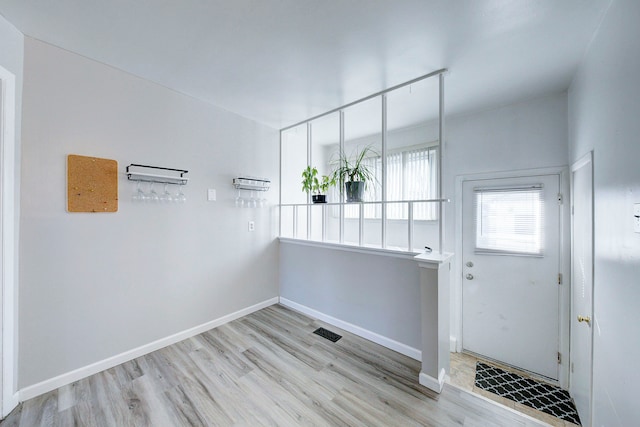 entrance foyer with visible vents, light wood-style flooring, and baseboards