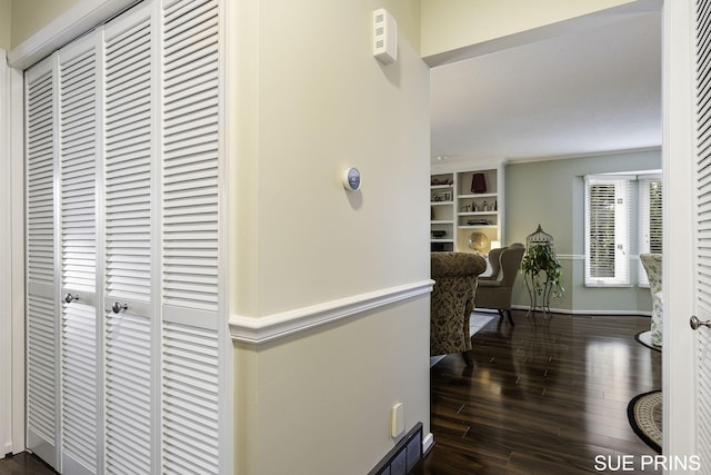 hallway with visible vents and dark wood-style floors