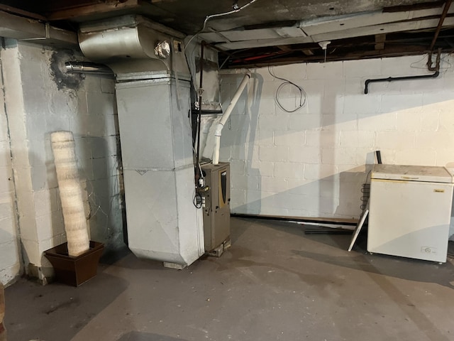 unfinished basement featuring heating unit