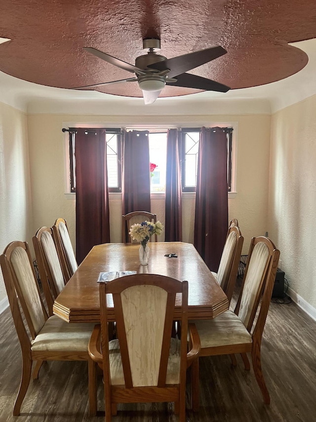 dining room featuring a textured ceiling, baseboards, ceiling fan, and dark wood-style flooring