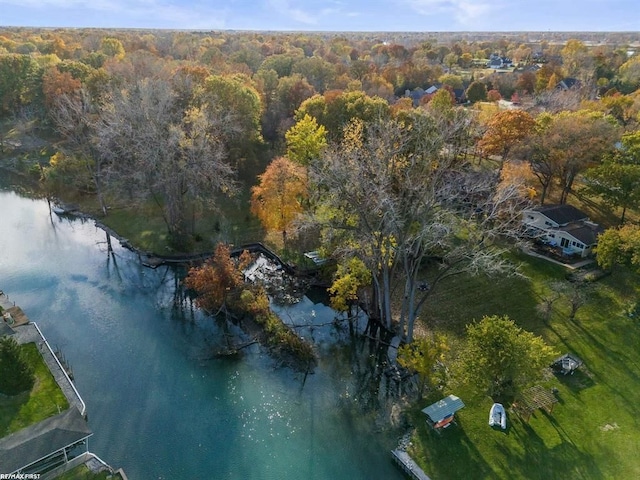 drone / aerial view with a wooded view and a water view