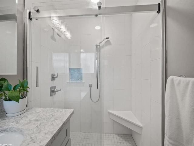 bathroom featuring a stall shower and vanity