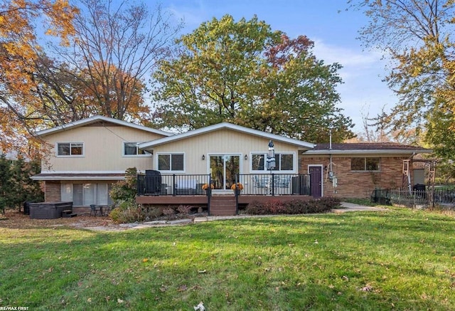 rear view of property featuring a deck and a yard