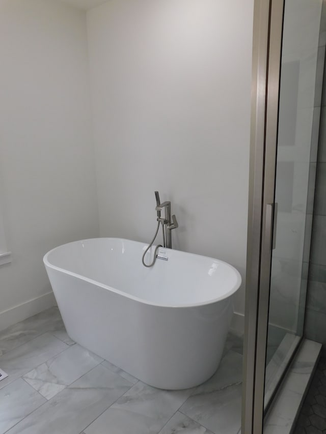 18978 Prairie St, Detroit, MI 48221 - full bath featuring a soaking tub, an enclosed shower, baseboards, and marble finish floor