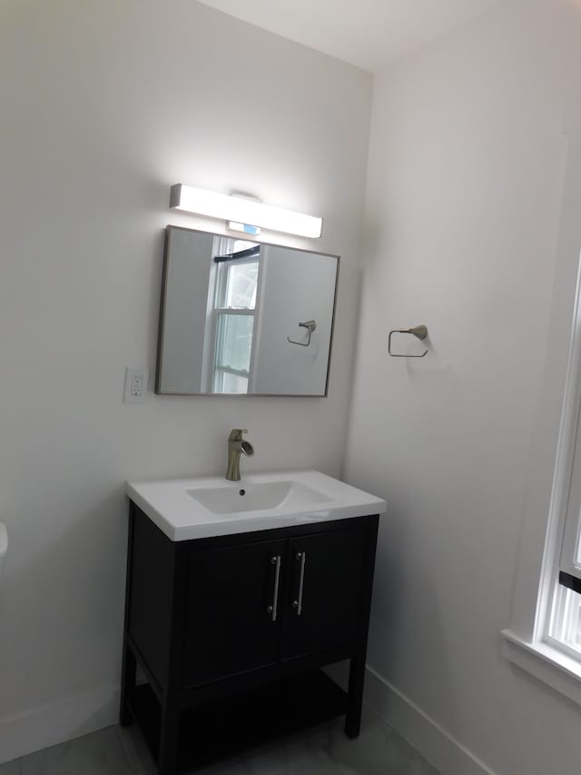 bathroom featuring baseboards and vanity