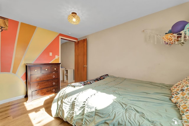 bedroom featuring baseboards and wood finished floors