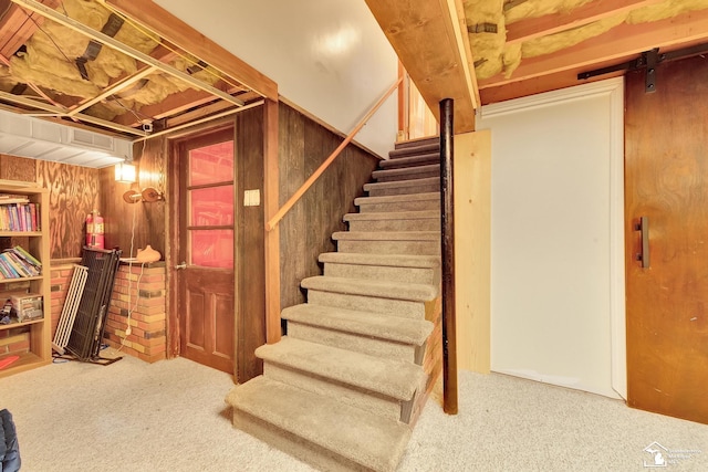 stairway with wooden walls and carpet