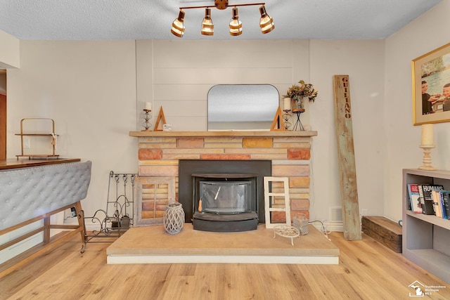 living area with wood finished floors and a textured ceiling