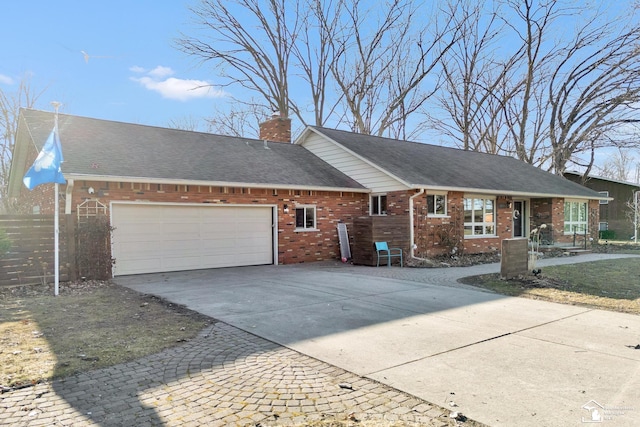 ranch-style house featuring driveway, roof with shingles, an attached garage, brick siding, and a chimney