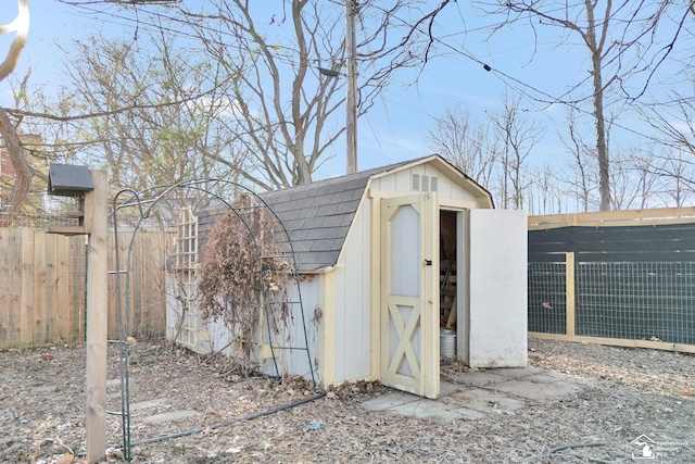 view of shed featuring fence