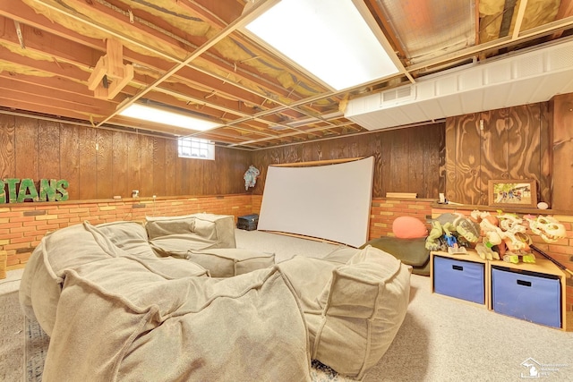 below grade area featuring carpet flooring and wood walls