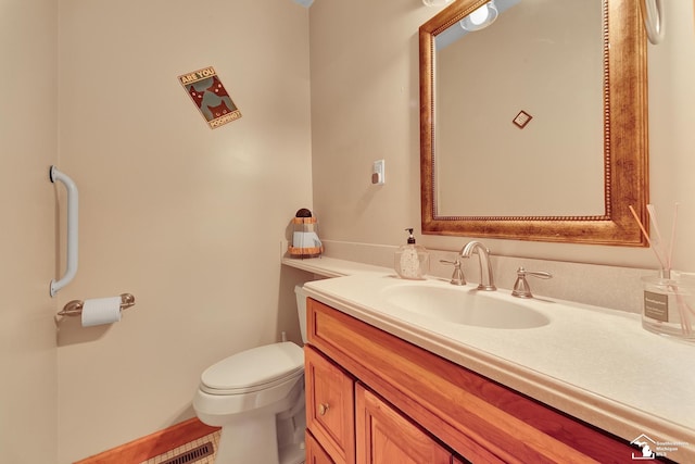 half bath with vanity, toilet, and visible vents