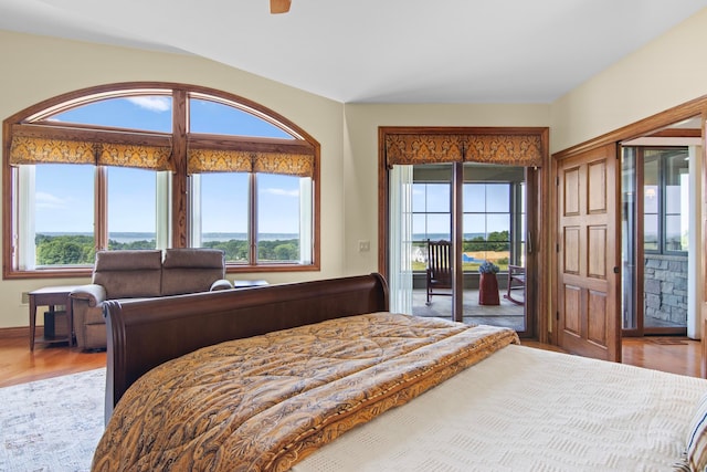 bedroom with wood finished floors and access to outside