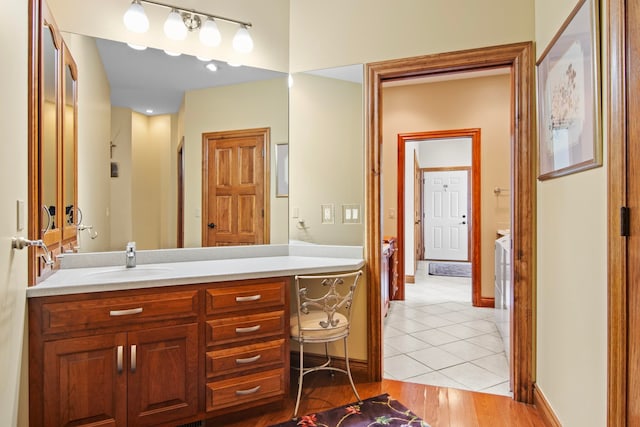 bathroom with vanity, tile patterned floors, and baseboards