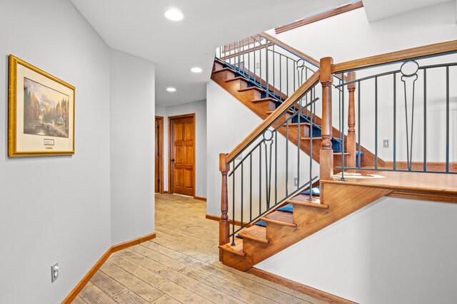 stairway with recessed lighting, baseboards, and wood-type flooring