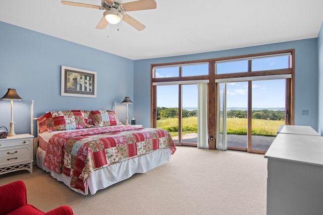 carpeted bedroom with ceiling fan and access to outside