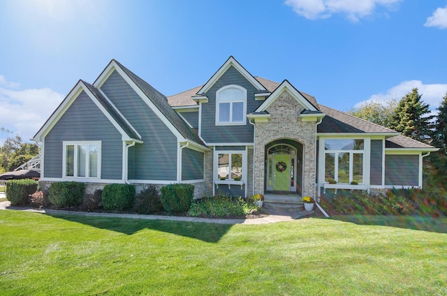 view of front of property featuring stone siding and a front lawn