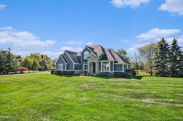 view of front of home featuring stone siding and a front yard