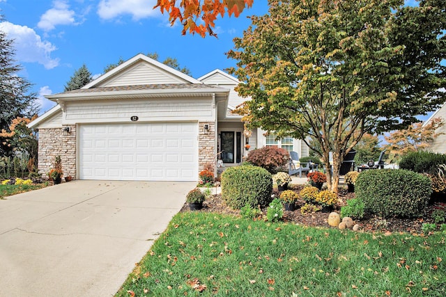 view of front facade with stone siding, driveway, and an attached garage