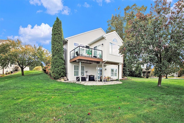 rear view of house with a wooden deck and a yard