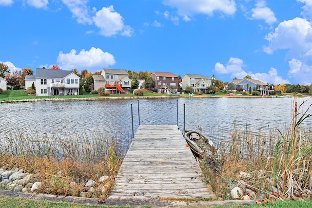 dock area with a residential view and a water view