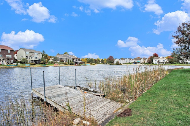 dock area with a residential view and a water view