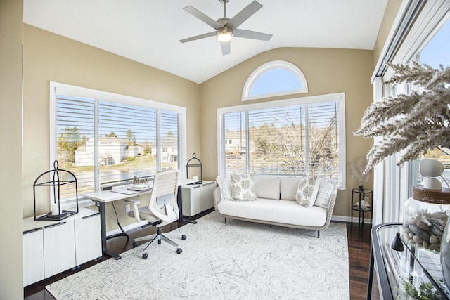 home office featuring baseboards, lofted ceiling, wood finished floors, and a ceiling fan