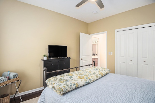 bedroom with a closet, baseboards, dark wood-style flooring, and a ceiling fan