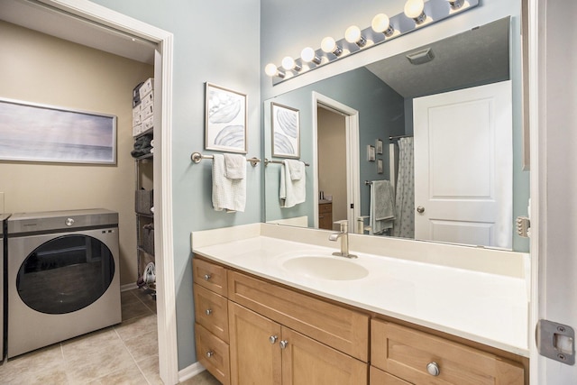 bathroom with tile patterned floors, washer / clothes dryer, and vanity