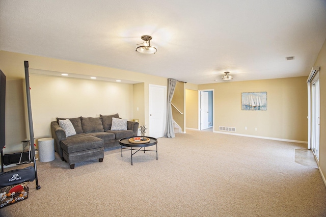 living area with stairs, carpet, visible vents, and baseboards