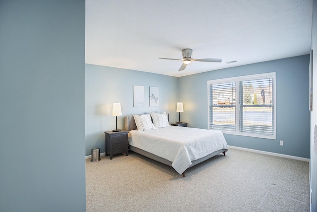 bedroom with baseboards, carpet floors, visible vents, and a ceiling fan