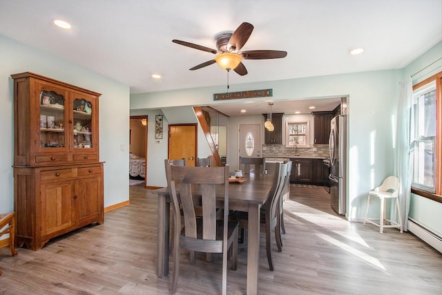 dining space with recessed lighting, baseboards, and light wood-style flooring