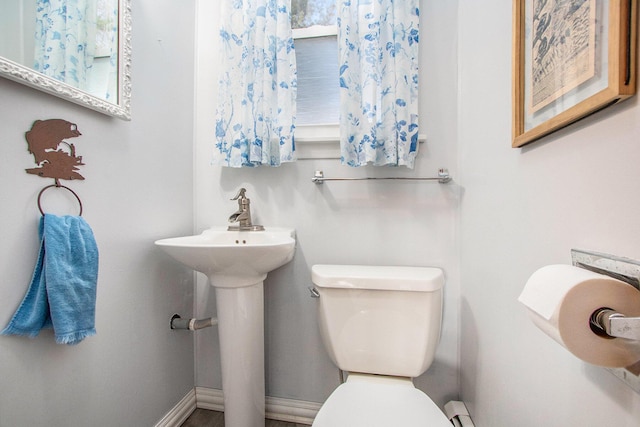 bathroom with toilet and baseboards