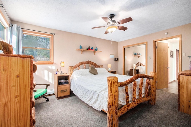 bedroom with ceiling fan, carpet, a closet, and a textured ceiling