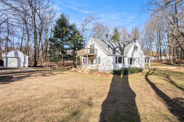 view of property exterior with an outbuilding, driveway, roof with shingles, a garage, and a lawn