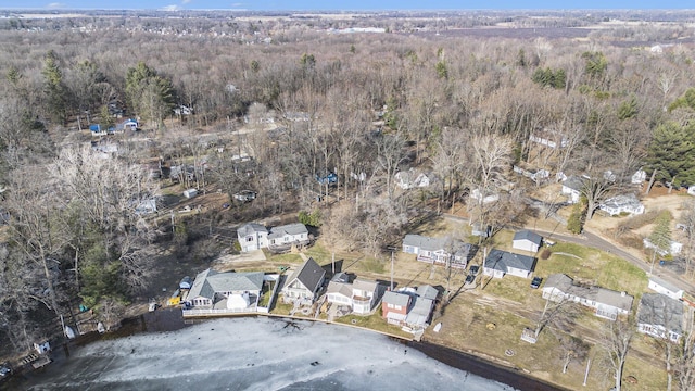 birds eye view of property featuring a forest view and a residential view