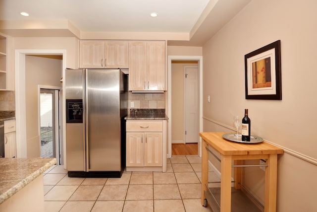 kitchen featuring light brown cabinetry, recessed lighting, stainless steel appliances, light tile patterned floors, and decorative backsplash