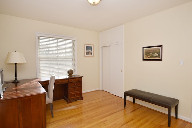 office area with light wood-style flooring and baseboards