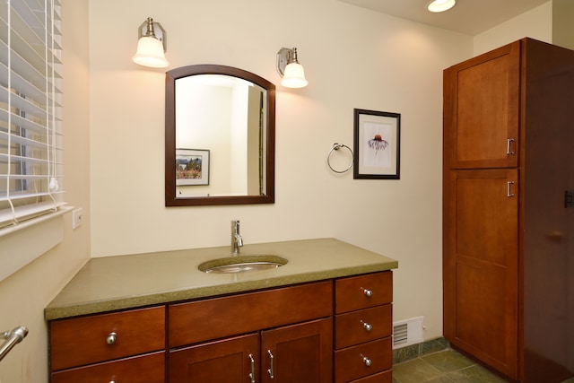 bathroom with vanity, visible vents, and tile patterned flooring