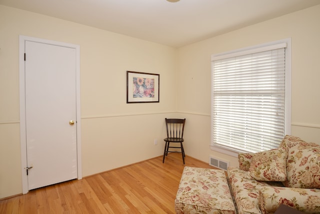 living area featuring visible vents and light wood finished floors