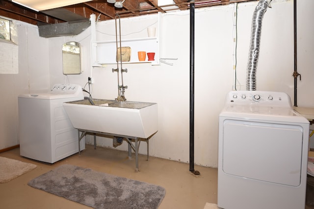 laundry room with laundry area, separate washer and dryer, and a sink