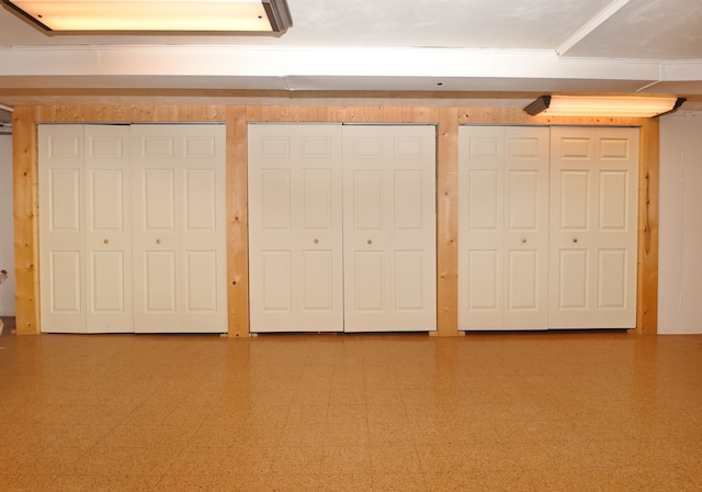 unfurnished bedroom featuring tile patterned floors and multiple closets