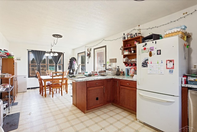 kitchen featuring open shelves, light floors, a peninsula, and freestanding refrigerator