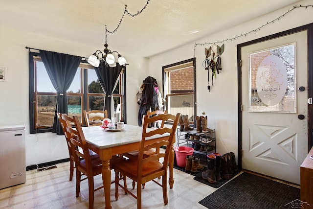 dining area featuring an inviting chandelier and light floors