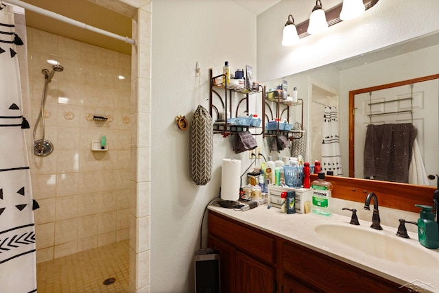 full bathroom featuring vanity and a tile shower