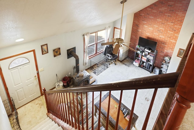 interior space featuring a textured ceiling and lofted ceiling